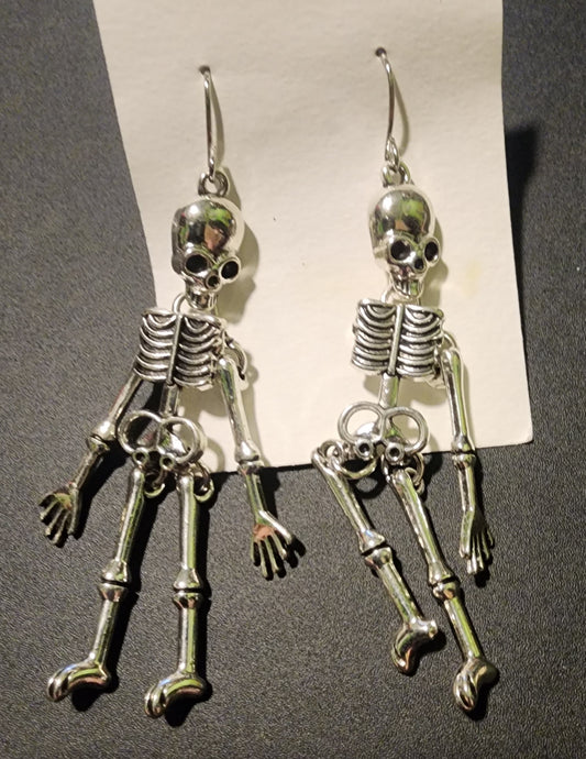 Silver Colored Skeleton Earrings *Missing An Arm*